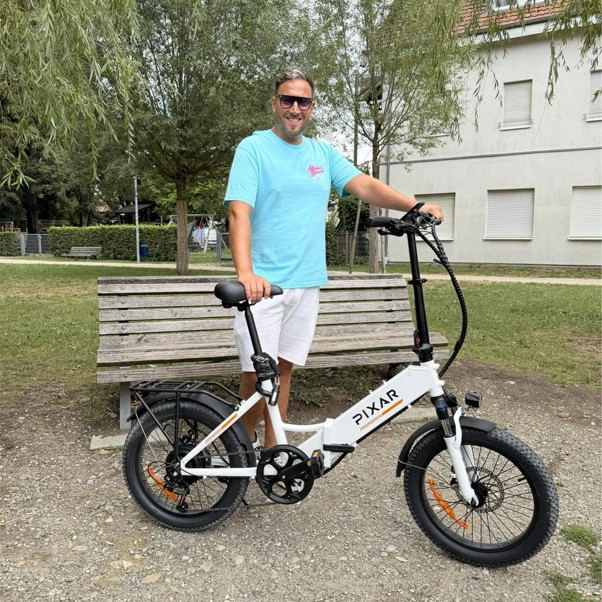 man in blue shirt standing with ebike