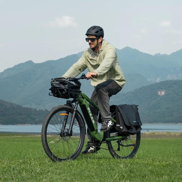 man riding an ebike near mountains