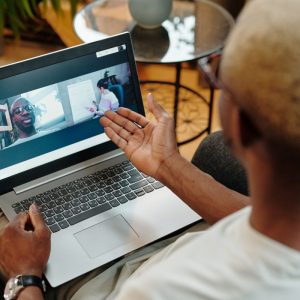 A person engages in a video call on their laptop in a relaxed home setting, fostering remote communication.