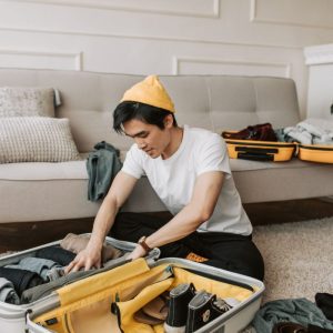 man packing luggage for a trip