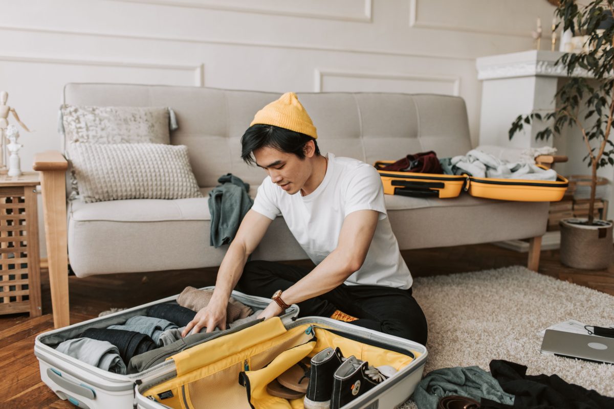 man packing luggage for a trip