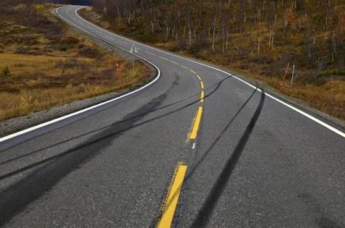 Skid marks and motorcycle debris following an evasive crash
