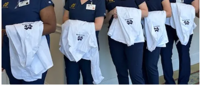 The white coats are emblematic of School of Nursing students who are eligible to celebrate their entrance into patient care.