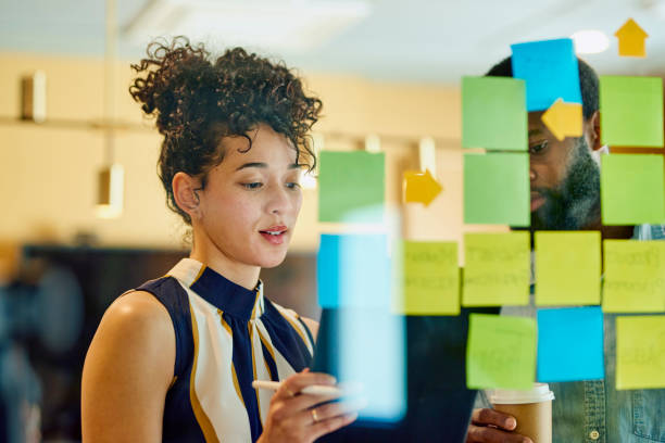 woman looking at sticky notes on a window