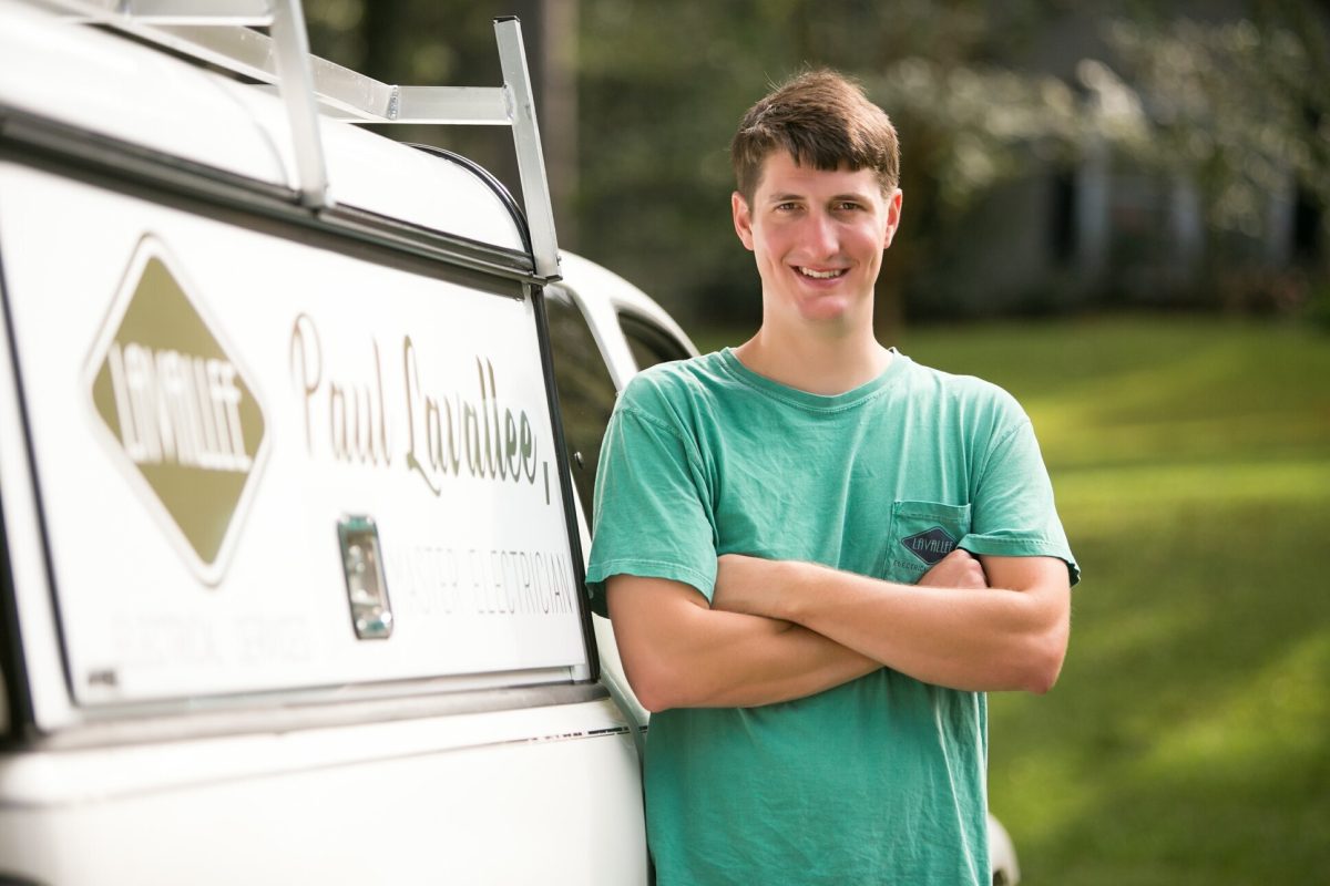 Paul Lavallee standing with arms crossed beside a Lavallee Electrical work truck