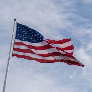 american flag on a pole flapping in the wind