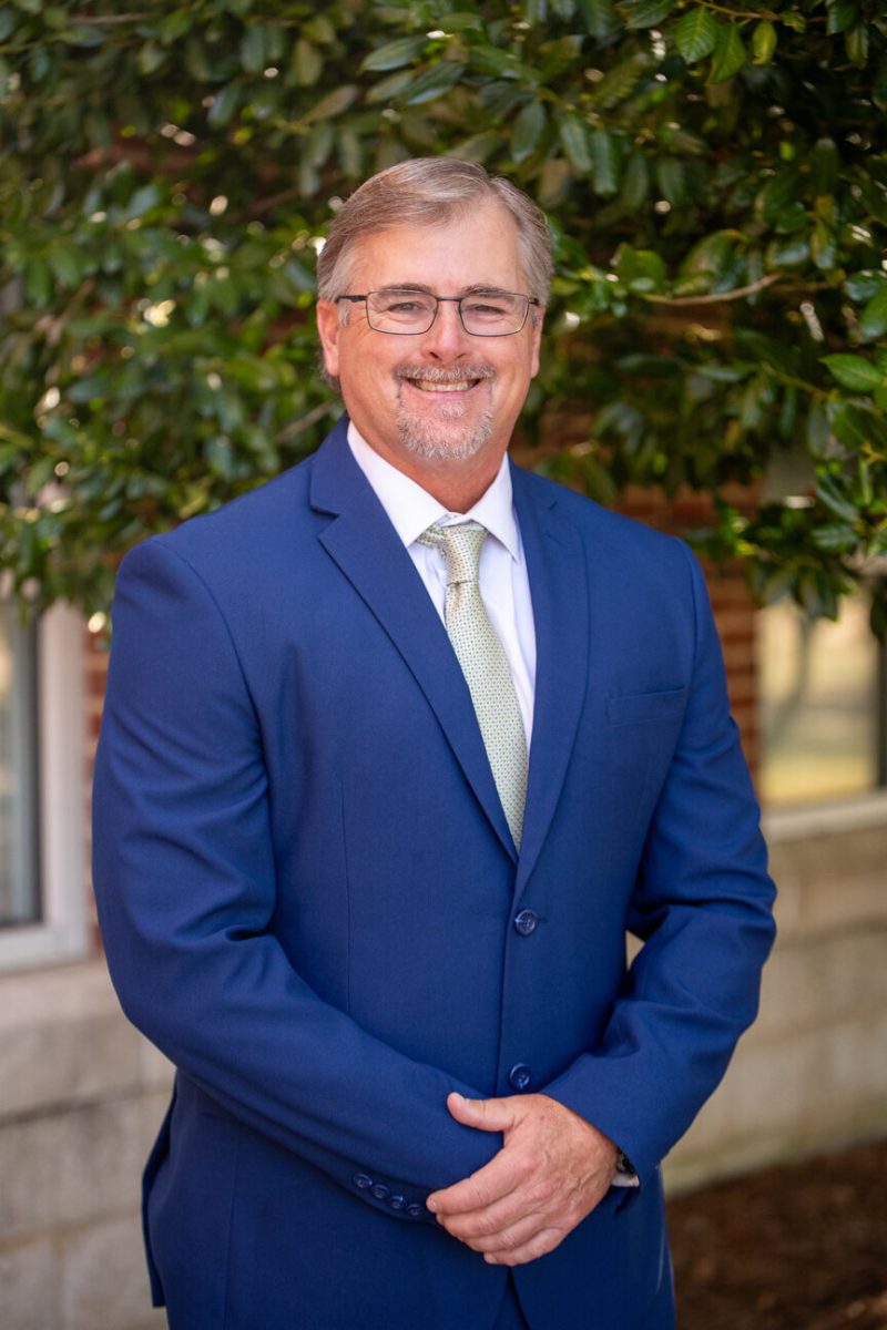 Portrait of Sam Temple in a blue suit