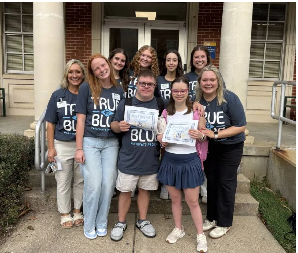True Blue Pathways students Timothy Miller, front row center, and JoJo Talley, front row, second from right, are enjoying their first semester of college at Mississippi Christian University. They are surrounded by Cindy Melton, left, MC professor of interdisciplinary studies and director of True Blue Pathways, and MC students who serve as peer coaches, Mallie Maffett, front row, second from left, Morgan Pipkin, front row, right, and back row, from left, Ally Mattern, Gabby Ayers, Lexie Elenkov and Josey Clark.