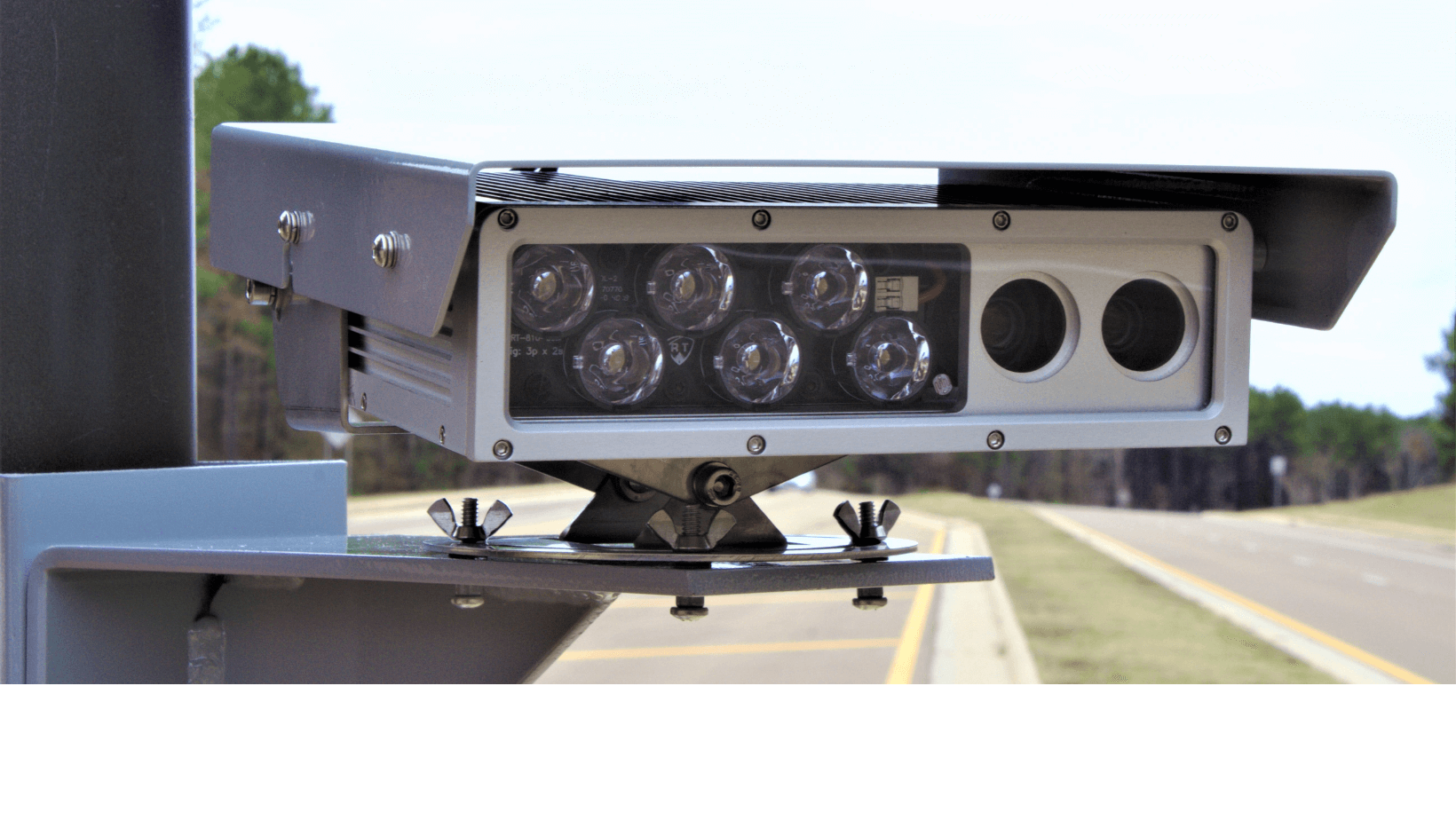 Close-up of an automatic license plate reader camera mounted beside a road