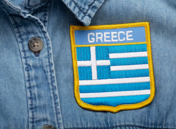 blue jean shirt with a greece emblem on the chest
