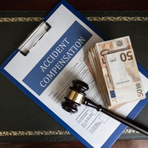 gavel and money on accident compensation paperwork