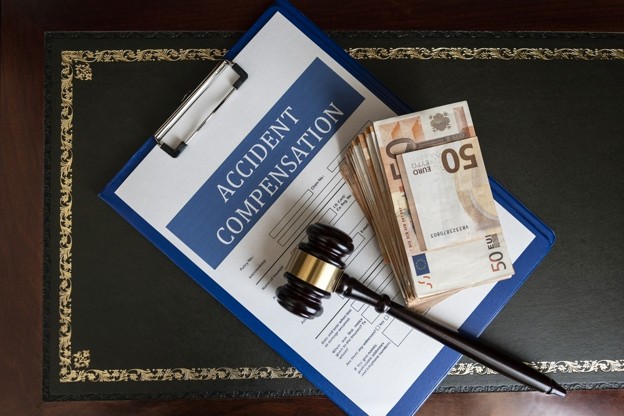 gavel and money on accident compensation paperwork
