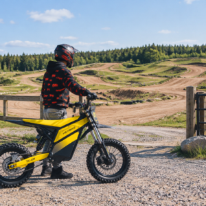 man holding yellow electric dirt bike