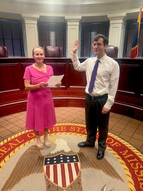Judge Virginia Carlton administering the oath to Bailey Morton in a courtroom