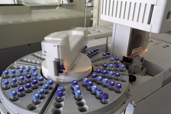 Rows of sample vials loaded in a laboratory chromatography instrument courtesy of Yuri Shkoda on Pexels
