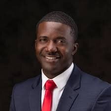Portrait of Ward 6 Alderman James Lott III in a dark suit and red tie