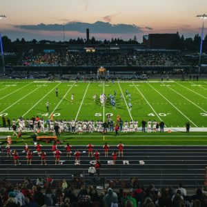 a football field with a crowd watching