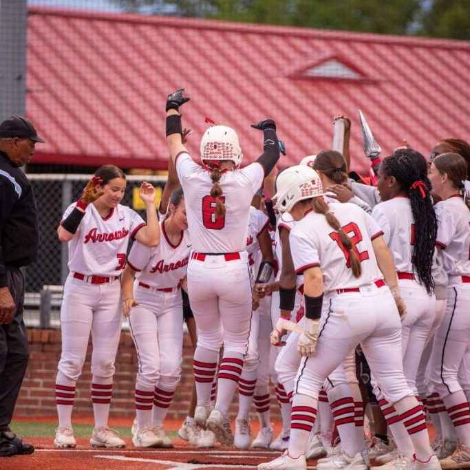 lady arrows softball celebrate at home base after no-hitter