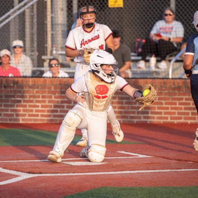 lady arrows softball catcher on knee catching ball