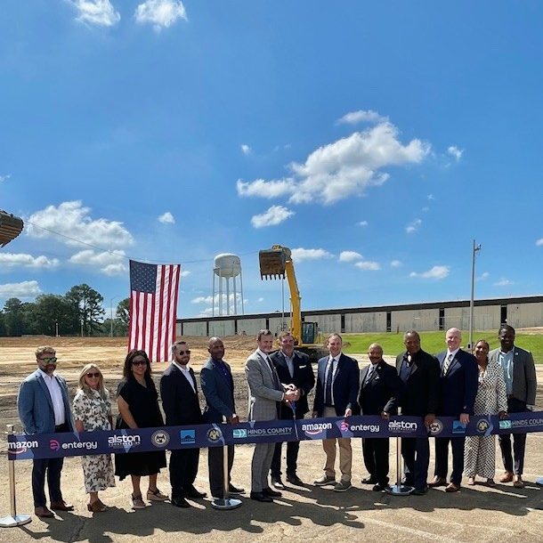 Clinton Mayor WIll Purdie joins AWS officials Roger Wehner to cut the ribbon at the data center site in Clinton as members of the Board of Aldermen and the Hinds Co. Supervisors watch.