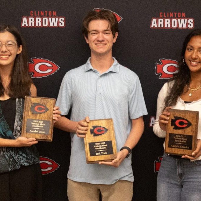Annabel Crane, Jack Tracy and Aashrita Cheruku holding plaques in front of a Clinton Arrows backdrop