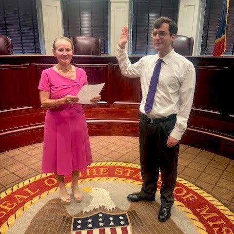 Judge Virginia Carlton administering the oath to Bailey Morton in a courtroom