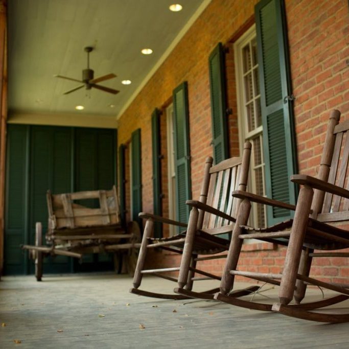 Rocking chairs on a covered porch at the Clinton Visitor Center